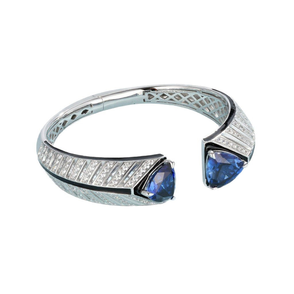 Elegant bracelet with blue gemstones and diamond accents on a white background