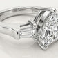 Side profile showing high prong basket setting and tapered baguette accent on silver ring.