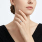 Elegant model wearing the round moissanite twisted vine ring, lifestyle view showing hand placement near face.
