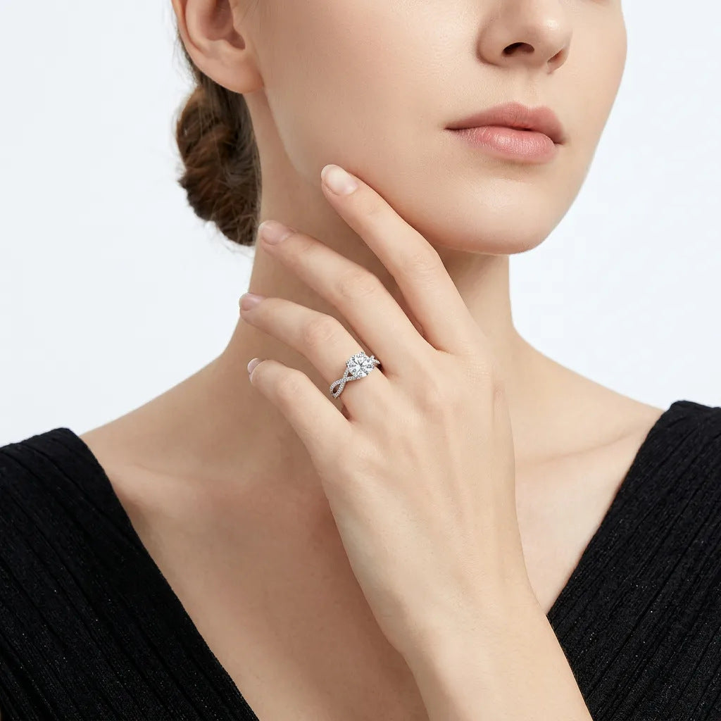 Elegant model wearing the round moissanite twisted vine ring, lifestyle view showing hand placement near face.