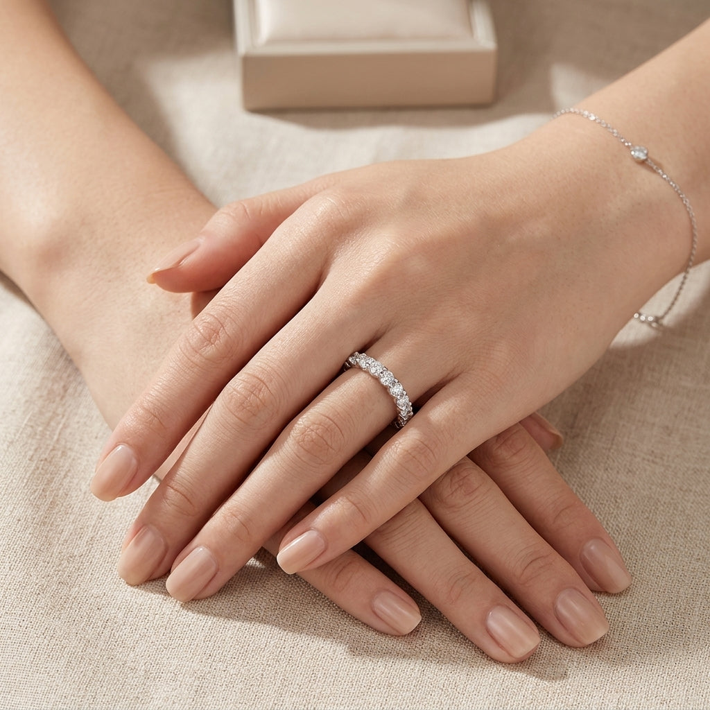 Close-up shot of hands wearing the classic U-shape moissanite half eternity wedding band.