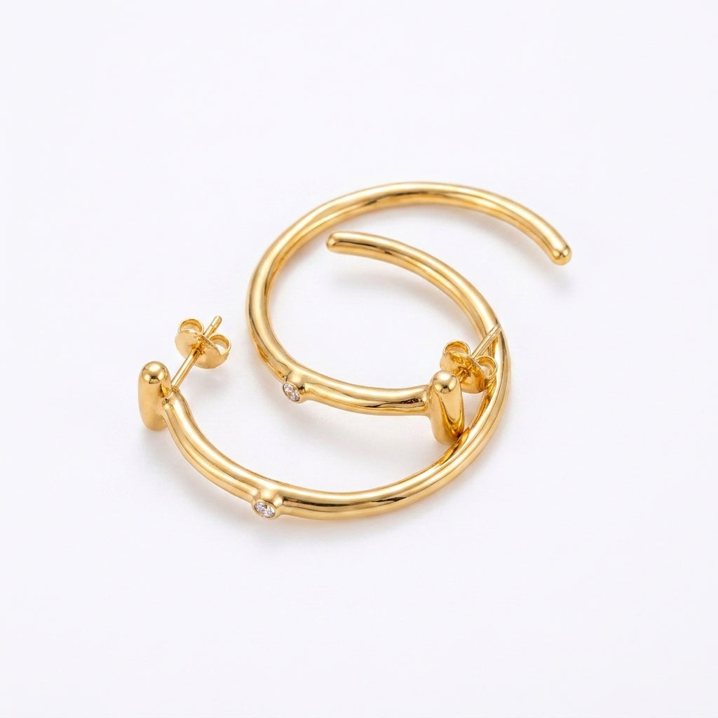 UNOde50 Ser Indomable Hoop Earrings featuring sterling silver plating and sparkling white topaz