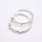 UNOde50 Ser Indomable Hoop Earrings featuring sterling silver plating and sparkling white topaz