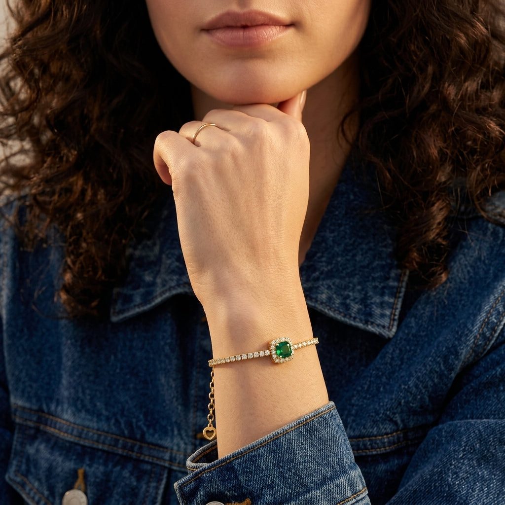 Lifestyle editorial portrait of a model showcasing a vintage cushion emerald chain bracelet draped elegantly over her wrist.