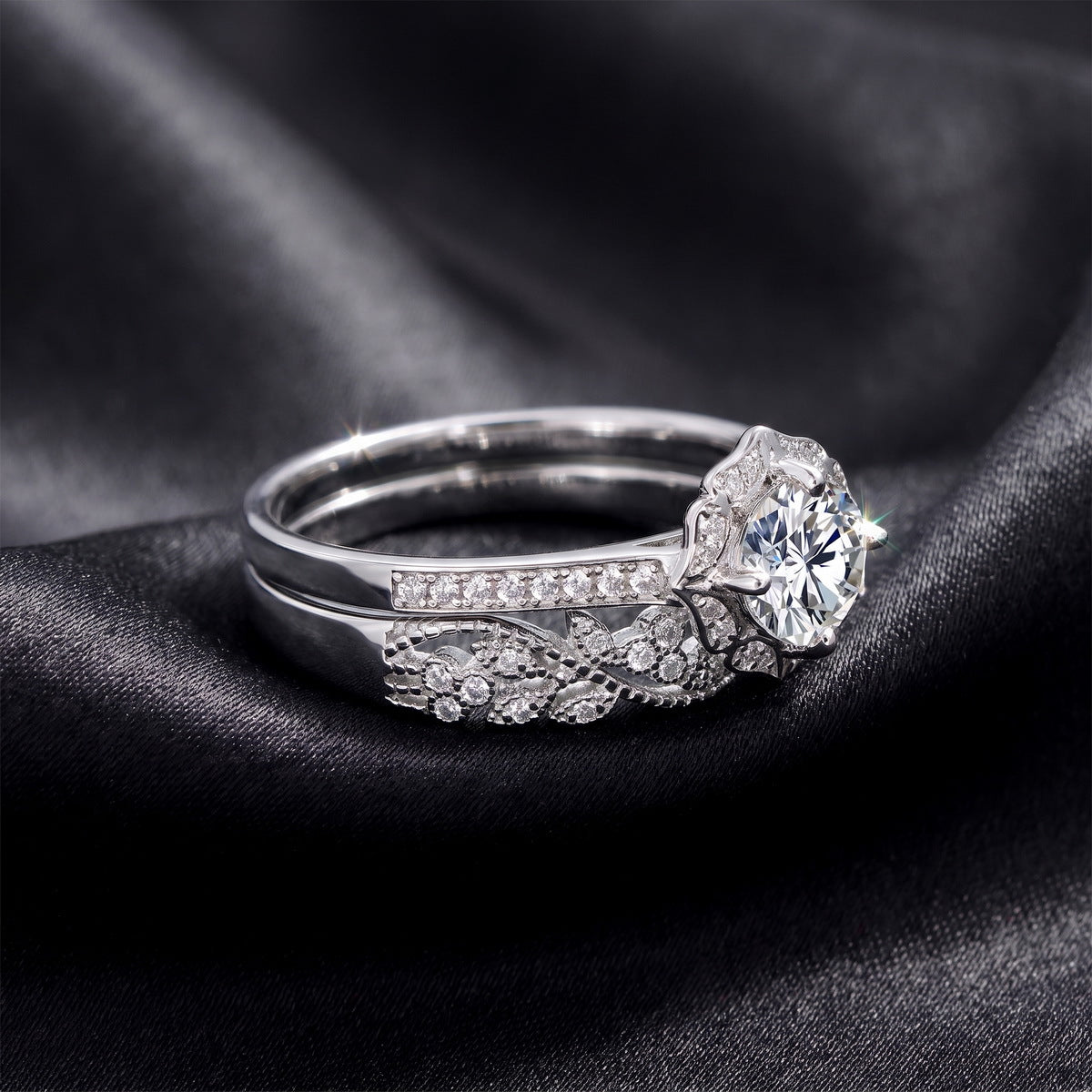 Vintage milgrain halo lab grown diamond engagement ring stacked with matching wedding band on dark black silk