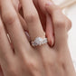 Woman wearing vintage milgrain halo lab grown diamond bridal ring set stacked on finger