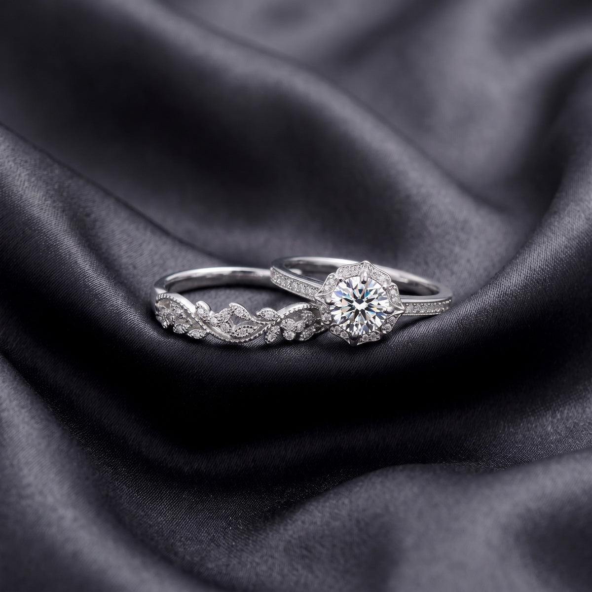 Side view of vintage milgrain halo lab grown diamond ring and matching contoured wedding band resting on dark silk