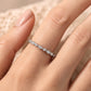 Woman wearing delicate vintage milgrain marquise and round lab grown diamond ring on finger