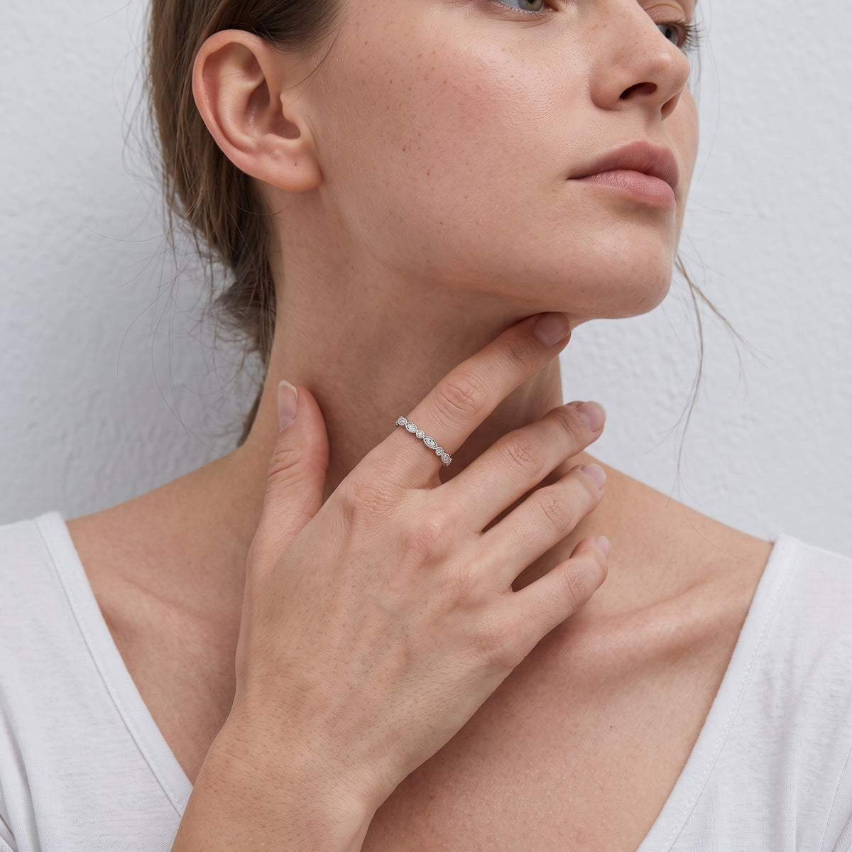 Close up of model wearing vintage milgrain marquise round lab grown diamond stacking ring in lifestyle setting