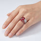 Close-up of a model wearing a luxury vintage crown ruby ring on her finger.