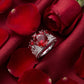Luxury ruby crown ring displayed on romantic rose petals for a classic vintage jewelry vibe.