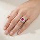 Side angle lifestyle shot of a model showcasing a vintage emerald-cut ruby double halo ring on her finger.