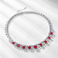 Flatlay view of a vintage cushion-cut ruby fringe statement necklace with soft shadows.