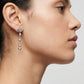 Model wearing the silver Tory Burch Moondance Pearl and Chain Earrings highlighting the dangling pearl aesthetic.