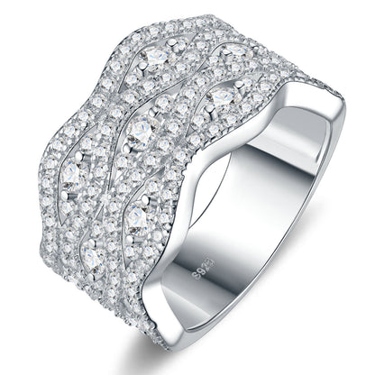Studio display of wide wave moissanite chunky pave crossover statement ring featuring organic fluid curves and full micro-pave setting.