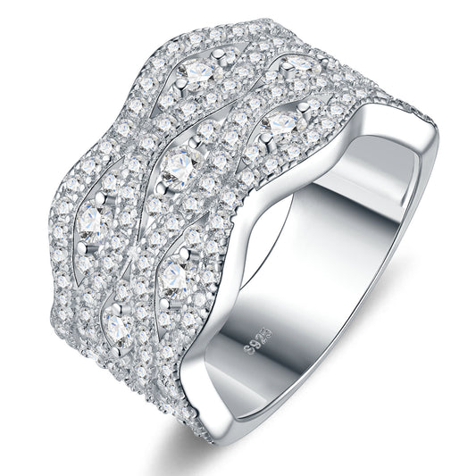Studio display of wide wave moissanite chunky pave crossover statement ring featuring organic fluid curves and full micro-pave setting.