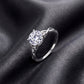 Perspective shot of round brilliant woven infinity solitaire ring on dark silk.