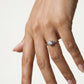 Full hand shot of model wearing round brilliant woven infinity solitaire ring.