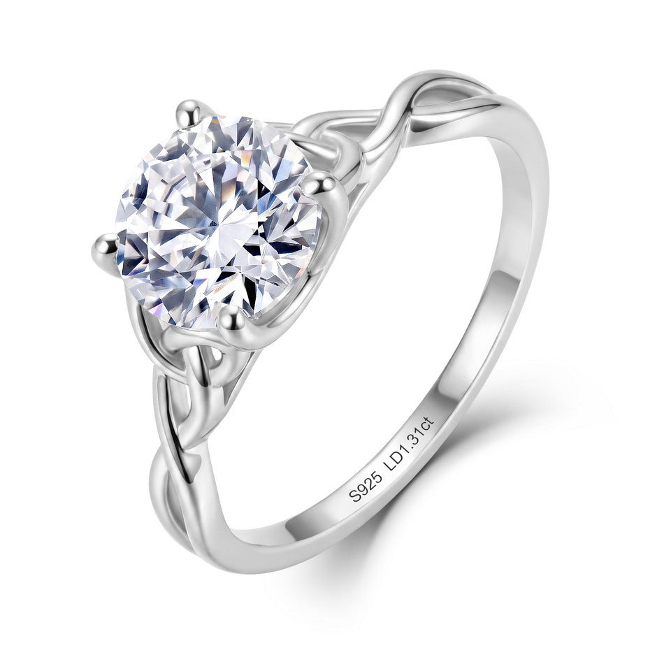 Side profile view of round solitaire ring showing woven infinity shank and prongs.