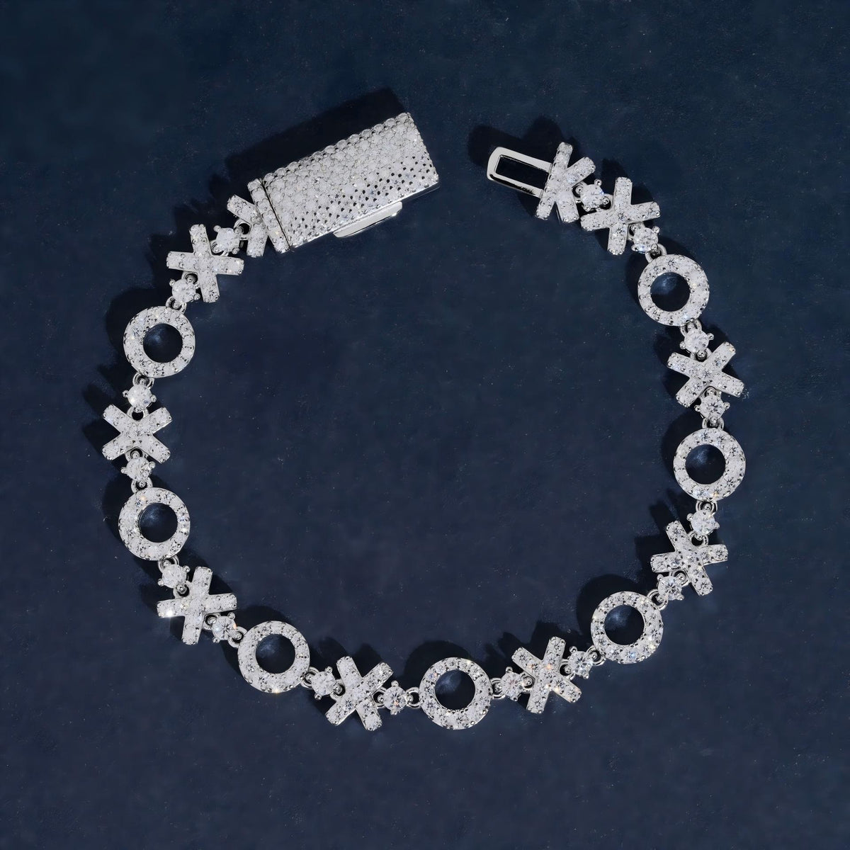 XOXO moissanite tennis bracelet in 925 sterling silver with iced out box clasp.